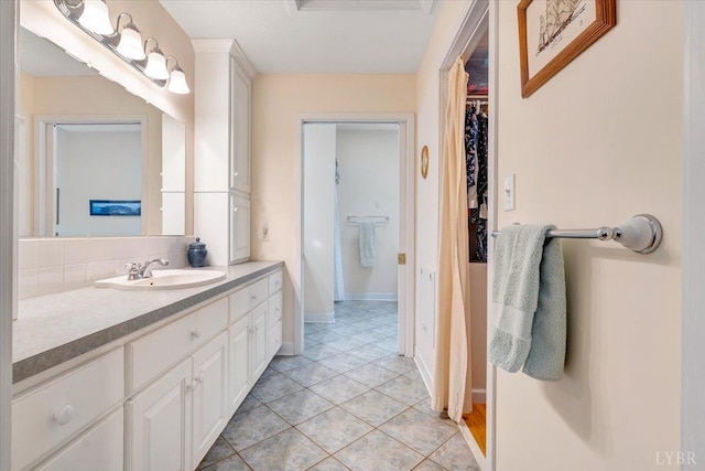 806 Cedar Key Ln, Huddleston, VA 24104 - bathroom with vanity, a spacious closet, backsplash, and tile patterned flooring