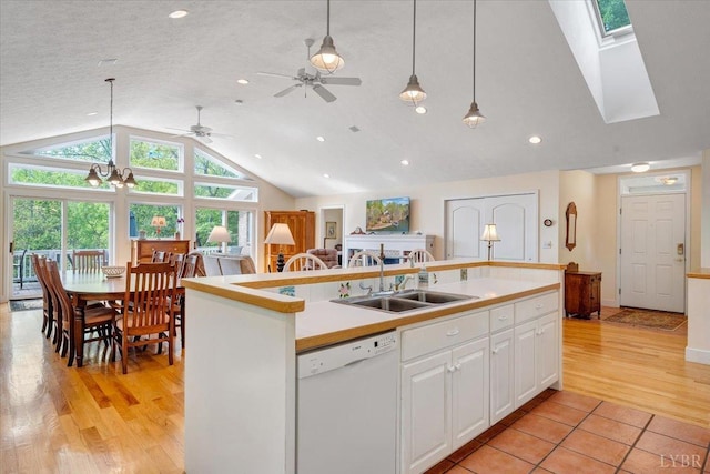 806 Cedar Key Ln, Huddleston, VA 24104 - kitchen featuring white dishwasher, lofted ceiling, a kitchen island with sink, white cabinetry, and pendant lighting