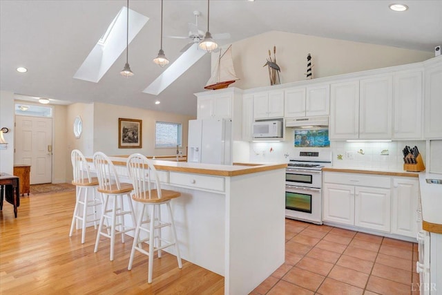 806 Cedar Key Ln, Huddleston, VA 24104 - kitchen with white appliances, a skylight, white cabinetry, a ceiling fan, and light countertops