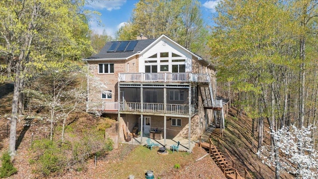806 Cedar Key Ln, Huddleston, VA 24104 - back of house featuring stairway, solar panels, a deck, a patio area, and brick siding
