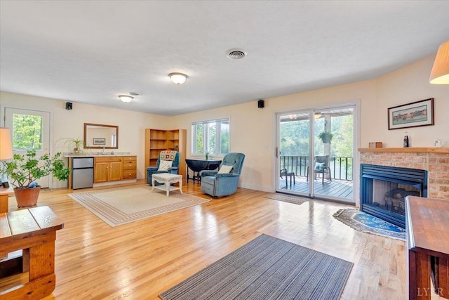 806 Cedar Key Ln, Huddleston, VA 24104 - living room featuring a brick fireplace, light wood-style floors, and healthy amount of natural light