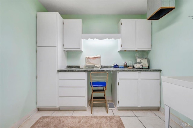 806 Cedar Key Ln, Huddleston, VA 24104 - kitchen featuring white cabinets, light tile patterned flooring, and dark countertops