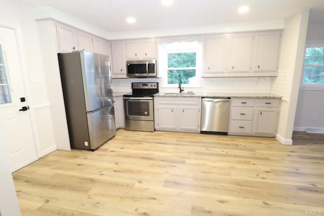 295 Charles Dr, Appomattox, VA 24522 - kitchen featuring stainless steel appliances, light wood-style floors, decorative backsplash, recessed lighting, and light stone countertops