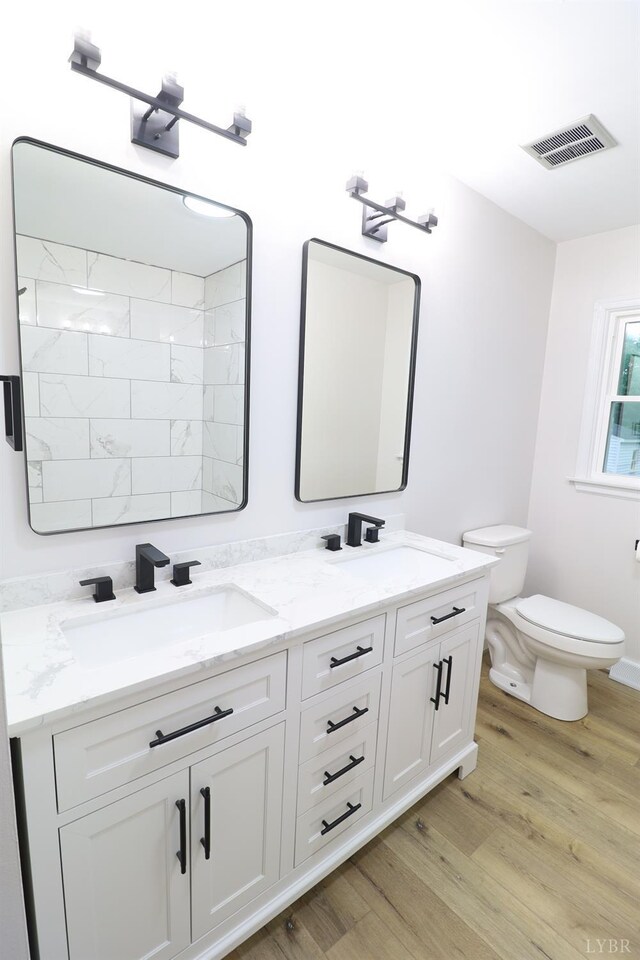 295 Charles Dr, Appomattox, VA 24522 - bathroom with double vanity and wood finished floors