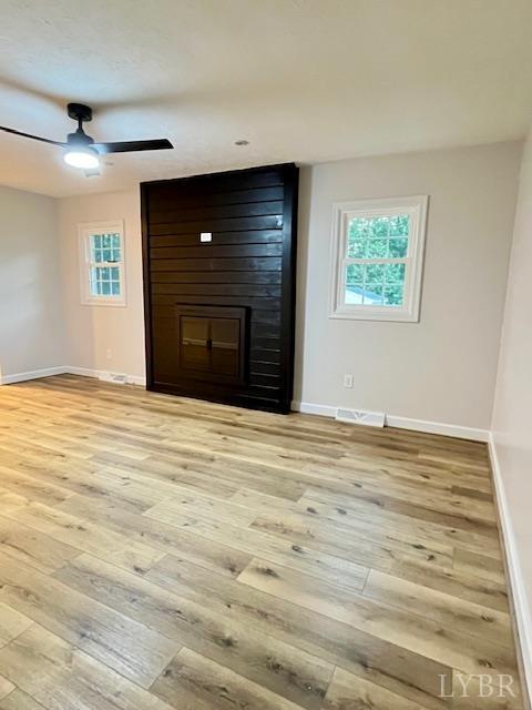 295 Charles Dr, Appomattox, VA 24522 - unfurnished living room featuring light wood finished floors, ceiling fan, and a fireplace
