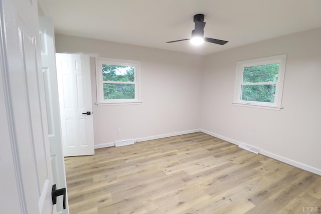 295 Charles Dr, Appomattox, VA 24522 - empty room with healthy amount of natural light, a ceiling fan, and light wood-style floors