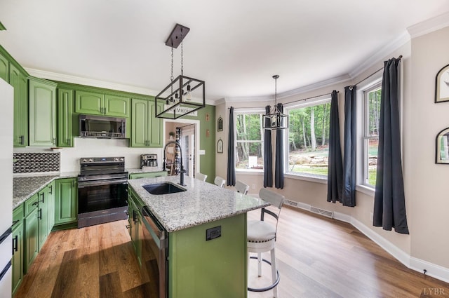 135 Warner Rd, Lynchburg, VA 24504 - kitchen with green cabinetry, appliances with stainless steel finishes, a sink, light wood finished floors, and a breakfast bar area