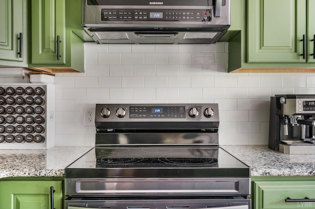 135 Warner Rd, Lynchburg, VA 24504 - kitchen featuring stainless steel electric range oven, green cabinetry, backsplash, exhaust hood, and light stone counters