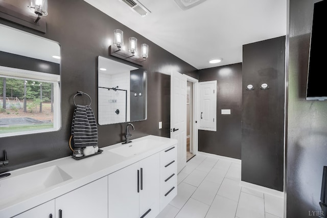135 Warner Rd, Lynchburg, VA 24504 - bathroom featuring a tile shower, double vanity, baseboards, and tile patterned flooring