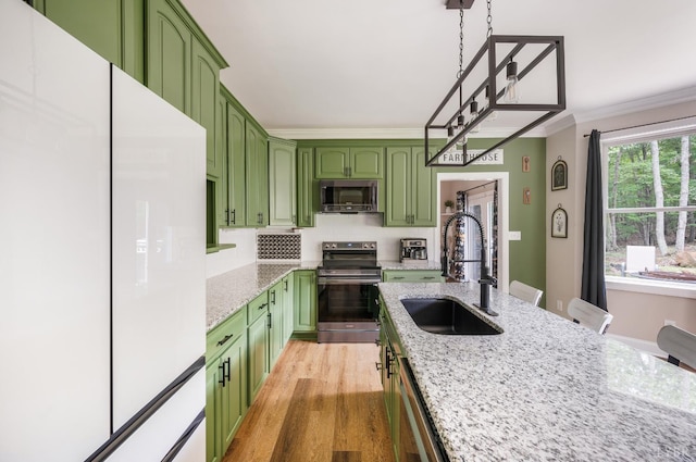 135 Warner Rd, Lynchburg, VA 24504 - kitchen featuring green cabinetry, stainless steel appliances, a sink, light stone countertops, and crown molding