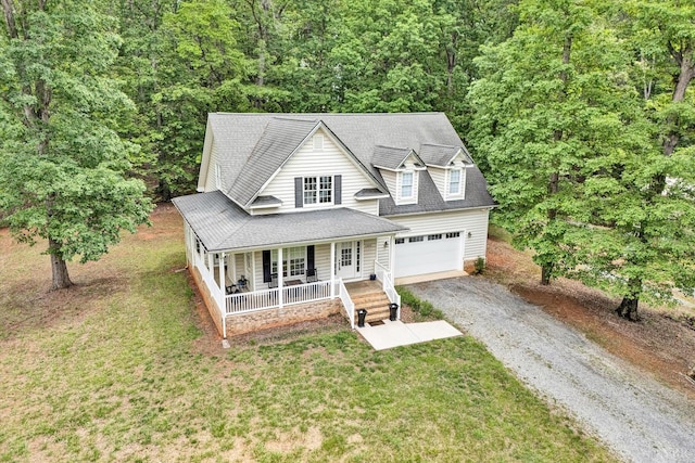 1309 W Pine Ridge Rd, Huddleston, VA 24014 - view of front facade with a porch, gravel driveway, a wooded view, a front yard, and a shingled roof