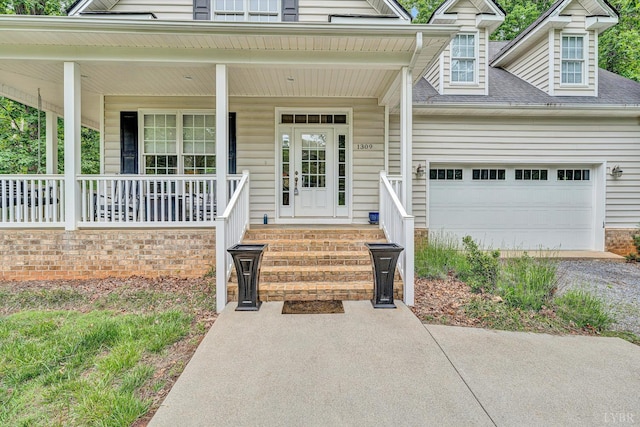 1309 W Pine Ridge Rd, Huddleston, VA 24014 - view of exterior entry with driveway, a porch, an attached garage, and roof with shingles