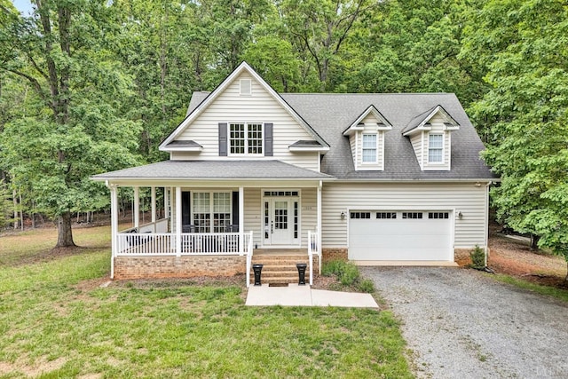 1309 W Pine Ridge Rd, Huddleston, VA 24014 - view of front of house with covered porch, gravel driveway, a front yard, a shingled roof, and a garage