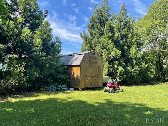 202 Leftwich St, Gretna, VA 24557 - view of grassy yard with a storage shed and an outbuilding