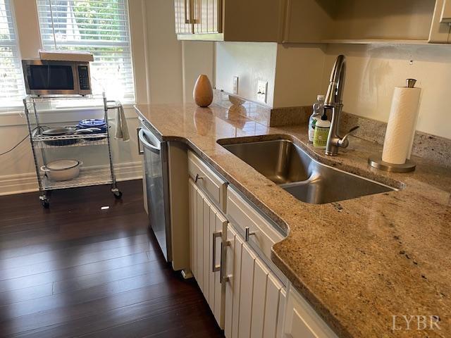 202 Leftwich St, Gretna, VA 24557 - kitchen with appliances with stainless steel finishes, healthy amount of natural light, dark wood-style flooring, and light stone counters