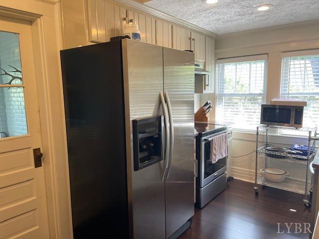 202 Leftwich St, Gretna, VA 24557 - kitchen featuring appliances with stainless steel finishes, ornamental molding, dark wood-type flooring, extractor fan, and a textured ceiling
