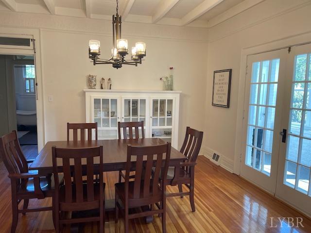 202 Leftwich St, Gretna, VA 24557 - dining room with french doors, a chandelier, beamed ceiling, wood finished floors, and baseboards