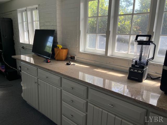 202 Leftwich St, Gretna, VA 24557 - kitchen with white cabinets and light stone counters