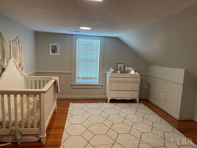 202 Leftwich St, Gretna, VA 24557 - bedroom featuring wood finished floors, a textured ceiling, and lofted ceiling