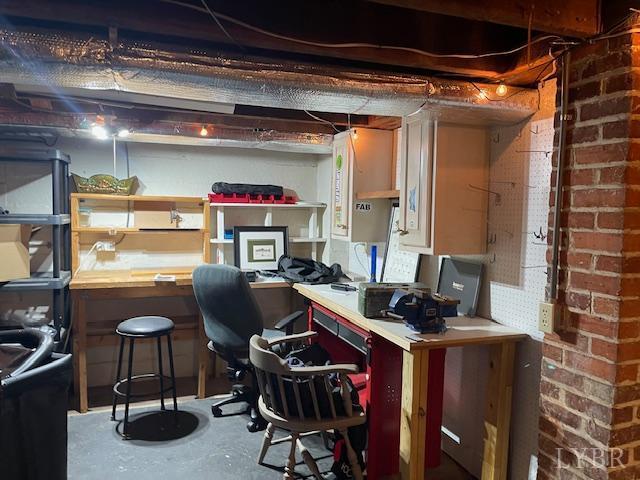 202 Leftwich St, Gretna, VA 24557 - office featuring concrete floors, a workshop area, and brick wall