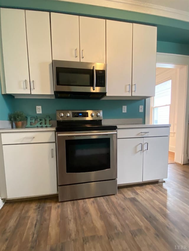 802 Erskine Ave, Lynchburg, VA 24501 - kitchen featuring appliances with stainless steel finishes, light countertops, white cabinets, and dark wood-type flooring