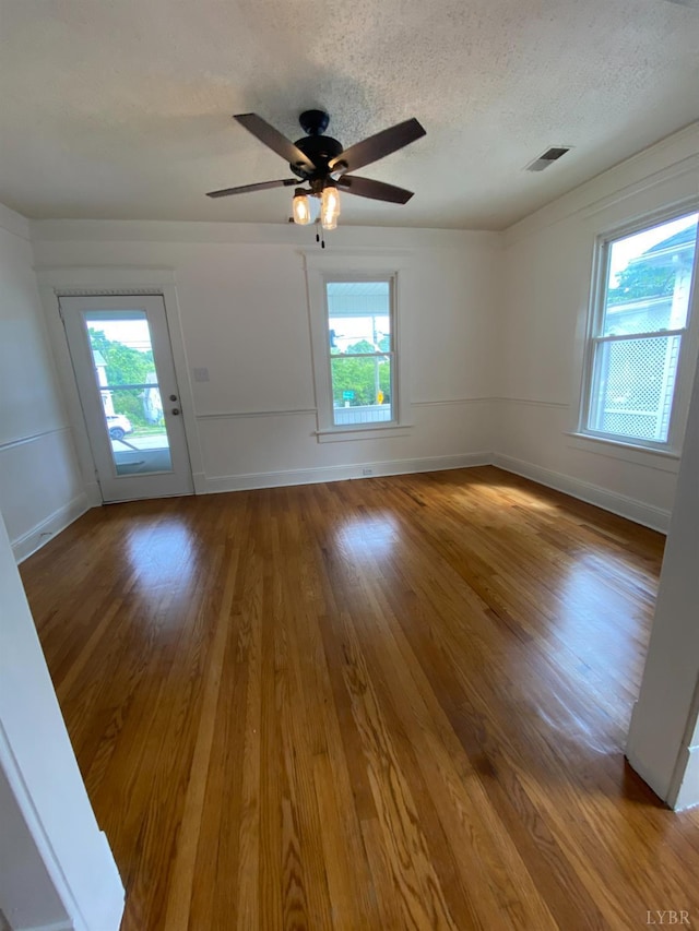 802 Erskine Ave, Lynchburg, VA 24501 - spare room with healthy amount of natural light, wood finished floors, a ceiling fan, and a textured ceiling