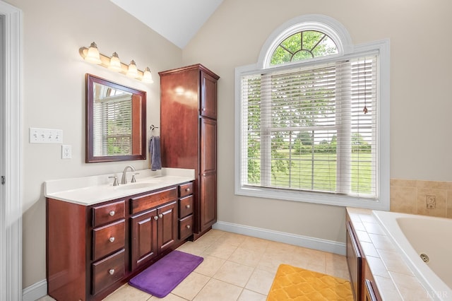 3374 Goode Station Rd, Goode, VA 24556 - bathroom with vaulted ceiling, vanity, a tub with jets, tile patterned floors, and baseboards