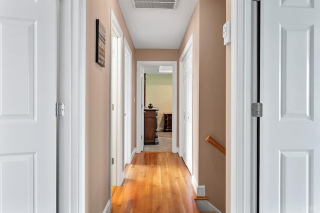 3374 Goode Station Rd, Goode, VA 24556 - hallway with an upstairs landing, light wood-type flooring, and baseboards