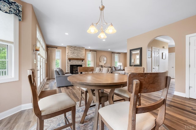 3374 Goode Station Rd, Goode, VA 24556 - dining room with wood finished floors, healthy amount of natural light, a fireplace, arched walkways, and recessed lighting