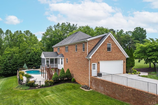 3374 Goode Station Rd, Goode, VA 24556 - rear view of property featuring a sunroom, a garage, stairs, brick siding, and concrete driveway