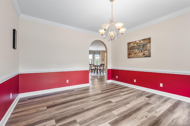 3374 Goode Station Rd, Goode, VA 24556 - spare room with arched walkways, a chandelier, wood finished floors, crown molding, and baseboards
