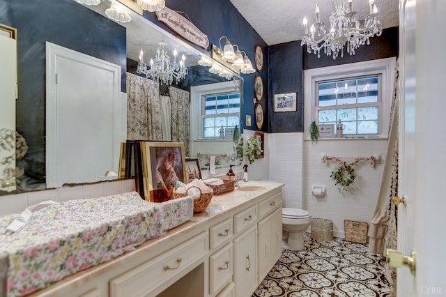 2770 W Lynchburg Salem Tpke, Bedford, VA 24523 - bathroom with a chandelier, tile walls, toilet, vanity, and tile patterned floors