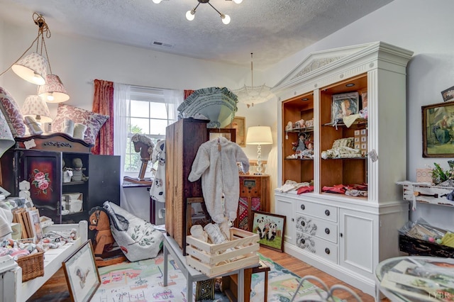 2770 W Lynchburg Salem Tpke, Bedford, VA 24523 - bedroom with a textured ceiling, wood finished floors, and a chandelier