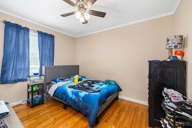 702 11th St, Altavista, VA 24517 - bedroom with hardwood / wood-style floors, baseboards, ornamental molding, and a ceiling fan