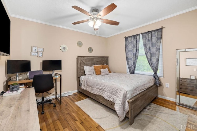 702 11th St, Altavista, VA 24517 - bedroom featuring hardwood / wood-style flooring, crown molding, an office area, baseboards, and a ceiling fan
