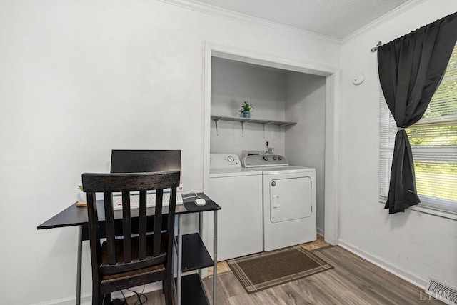 702 11th St, Altavista, VA 24517 - laundry room with washer and dryer, wood finished floors, crown molding, and baseboards