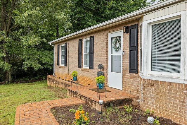 702 11th St, Altavista, VA 24517 - doorway to property with brick siding and a yard