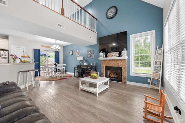 314 Cooper Way, Evington, VA 24550 - living area with high vaulted ceiling, a chandelier, wood finished floors, baseboards, and healthy amount of natural light