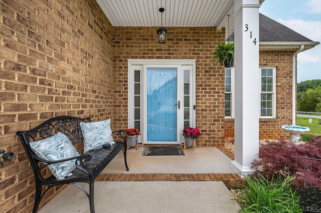 314 Cooper Way, Evington, VA 24550 - property entrance with brick siding, a porch, and a shingled roof