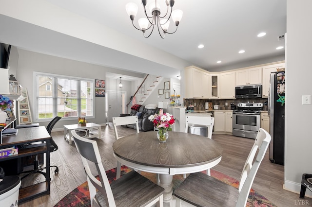 314 Cooper Way, Evington, VA 24550 - dining room featuring stairway, light wood-type flooring, recessed lighting, baseboards, and a chandelier