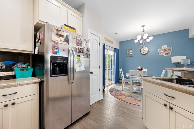 314 Cooper Way, Evington, VA 24550 - kitchen featuring stainless steel refrigerator with ice dispenser, a chandelier, white cabinetry, light wood-style floors, and pendant lighting