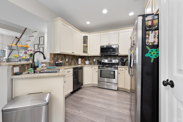 314 Cooper Way, Evington, VA 24550 - kitchen with appliances with stainless steel finishes, a sink, tasteful backsplash, glass insert cabinets, and a peninsula