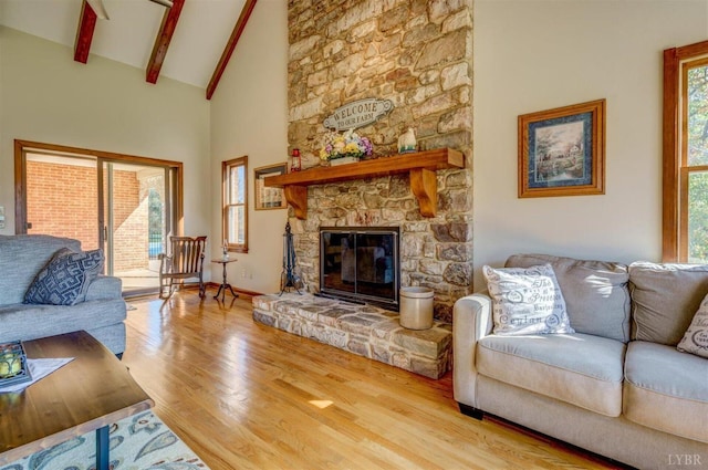 450 Holyfield Ln, Moneta, VA 24121 - living room with healthy amount of natural light, high vaulted ceiling, wood finished floors, beamed ceiling, and a fireplace