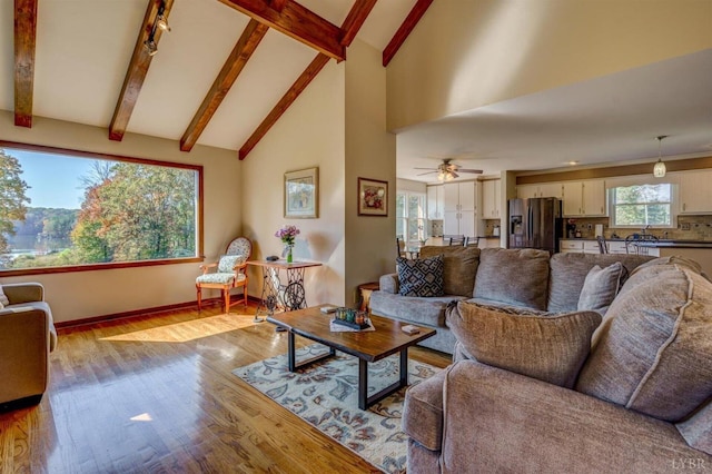 450 Holyfield Ln, Moneta, VA 24121 - living room featuring wood finished floors, beamed ceiling, high vaulted ceiling, and a ceiling fan