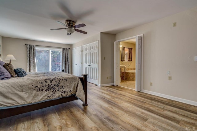 450 Holyfield Ln, Moneta, VA 24121 - bedroom with two closets, light wood-style flooring, connected bathroom, and ceiling fan