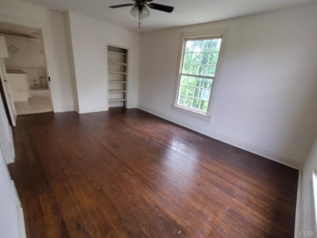 1503 Jackson St, Lynchburg, VA 24504 - spare room featuring built in features, ceiling fan, dark wood-style floors, and baseboards