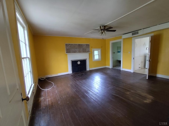1503 Jackson St, Lynchburg, VA 24504 - unfurnished living room featuring wood-type flooring, ceiling fan, a fireplace, and baseboards