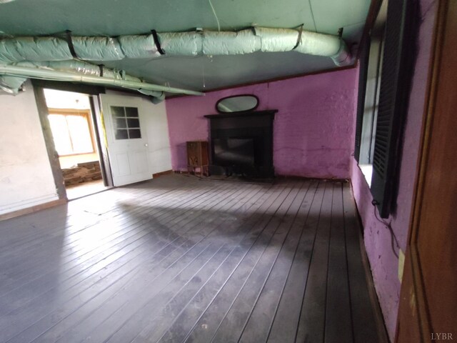 1503 Jackson St, Lynchburg, VA 24504 - unfurnished living room featuring wood-type flooring and a fireplace