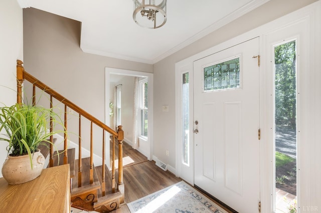 134 Woodmont Ln, Forest, VA 24551 - entryway with crown molding, wood finished floors, baseboards, stairs, and a chandelier