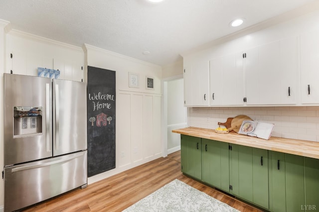134 Woodmont Ln, Forest, VA 24551 - kitchen with stainless steel refrigerator with ice dispenser, green cabinetry, butcher block countertops, ornamental molding, and light wood-type flooring